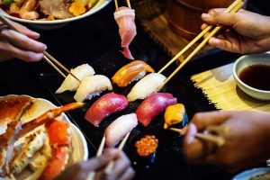 People eating sashimi.
