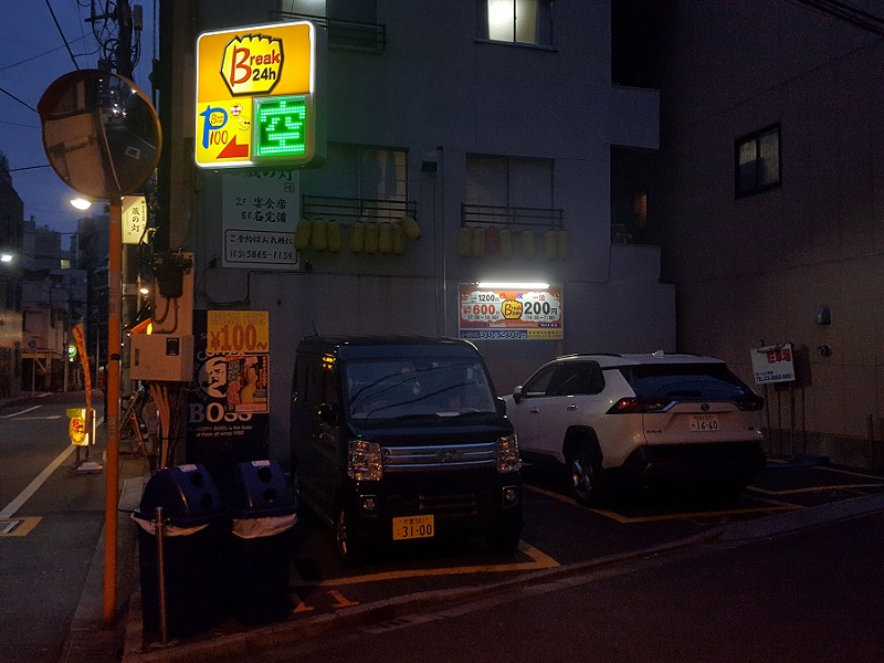 Three signs marking three spaces on a single parking lot