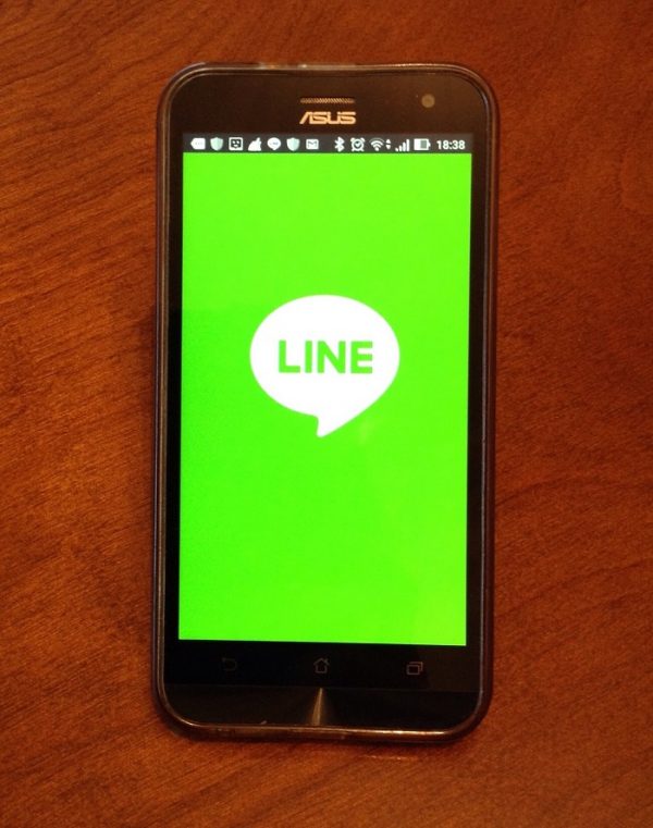 Smartphone screen showing the LINE app's green home screen logo.