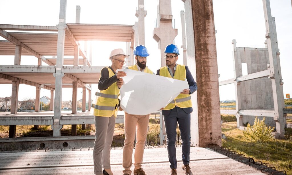 Construction workers examining blueprints, symbolizing the building blocks of Japanese grammar.