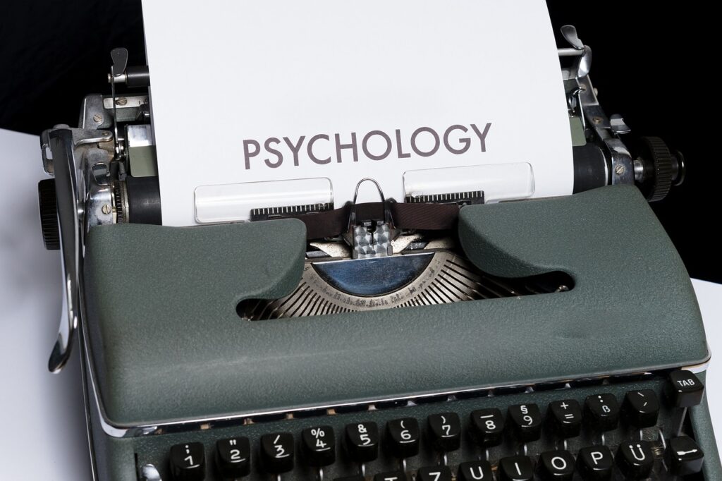 Vintage typewriter with the word "PSYCHOLOGY" typed on paper, symbolizing the role of psychology in effective language learning strategies.