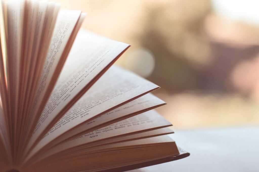 A close-up of an open book with pages fanning out.