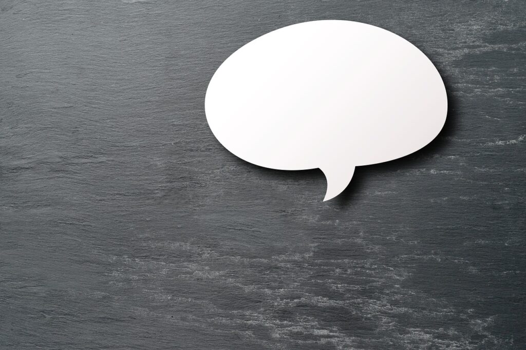 A speech bubble cutout on a slate background.