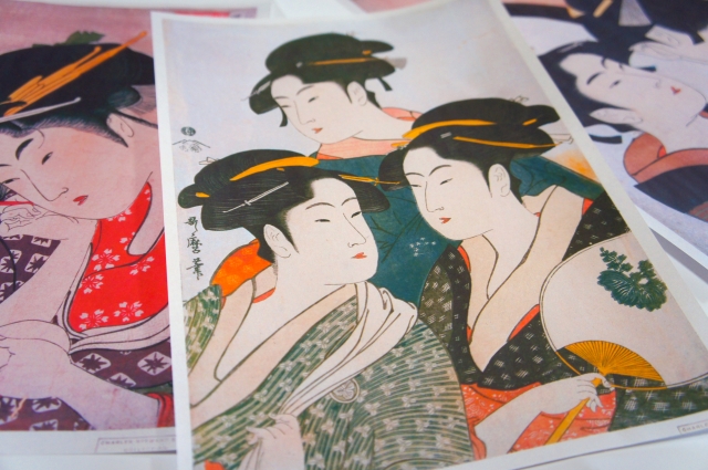 A collection of ukiyo-e prints depicting traditional Japanese women in beautiful kimonos.