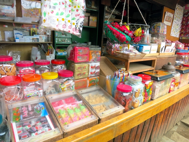 A colorful array of traditional Japanese candies and snacks displayed in a retro-style shop in Mejiro.