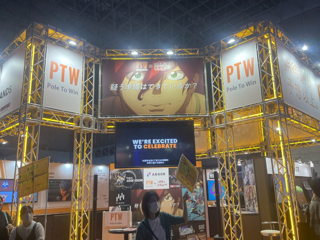 PTW (Pole To Win) booth showcasing bright banners and displays at Tokyo Game Show 2024.