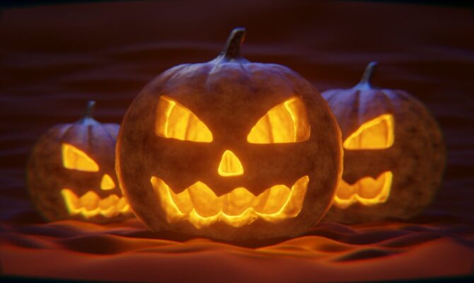 Three spooky Jack-o'-lanterns glowing eerily in the dark, each with a menacing grin.