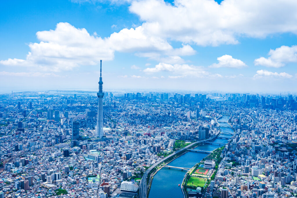 Aerial view of Tokyo skyline with Tokyo Skytree and river on a clear day.