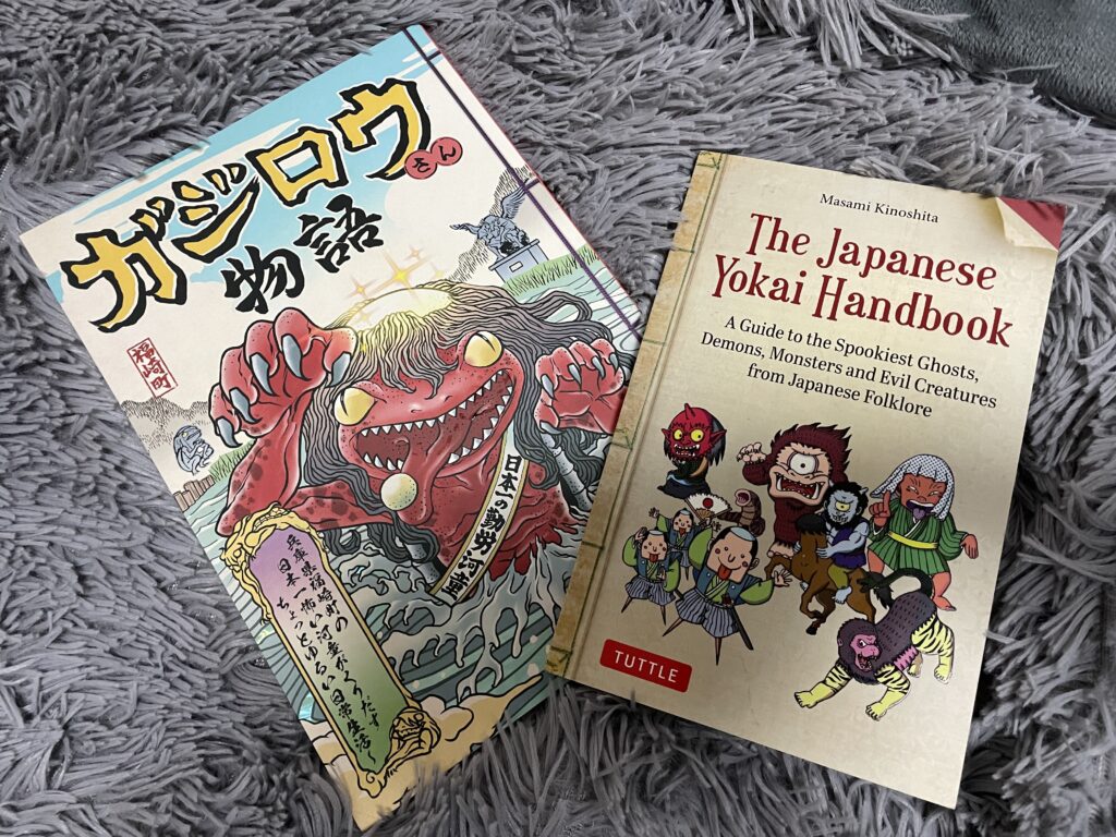 Two Japanese books about yokai, including "The Japanese Yokai Handbook" and a manga titled "Gajiro Stories."