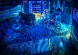 Shibuya Scramble Crossing at night illuminated by neon lights and bustling crowds.