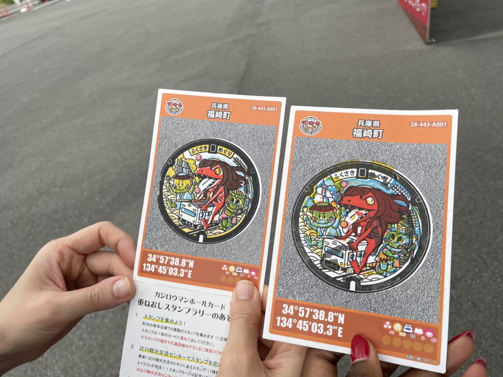 Colorful Fukusaki stamp cards with detailed illustrations of demons and the town’s coordinates.