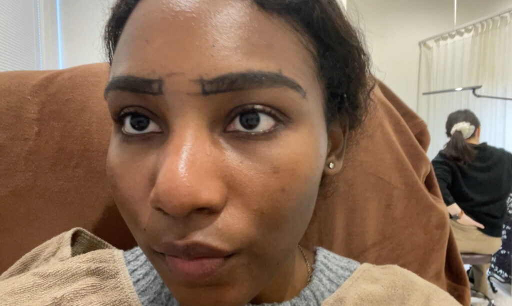 The client's eyebrows after waxing, with the mapped-out lines still visible.