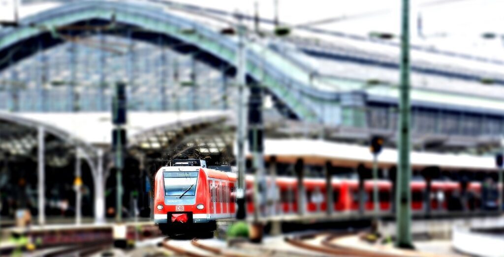 A red train arriving at a station, symbolizing Japan's advanced and accessible rail system.