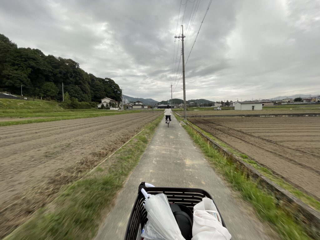 A view from a bike basket as tourists cycle through the peaceful countryside of Fukusaki City.