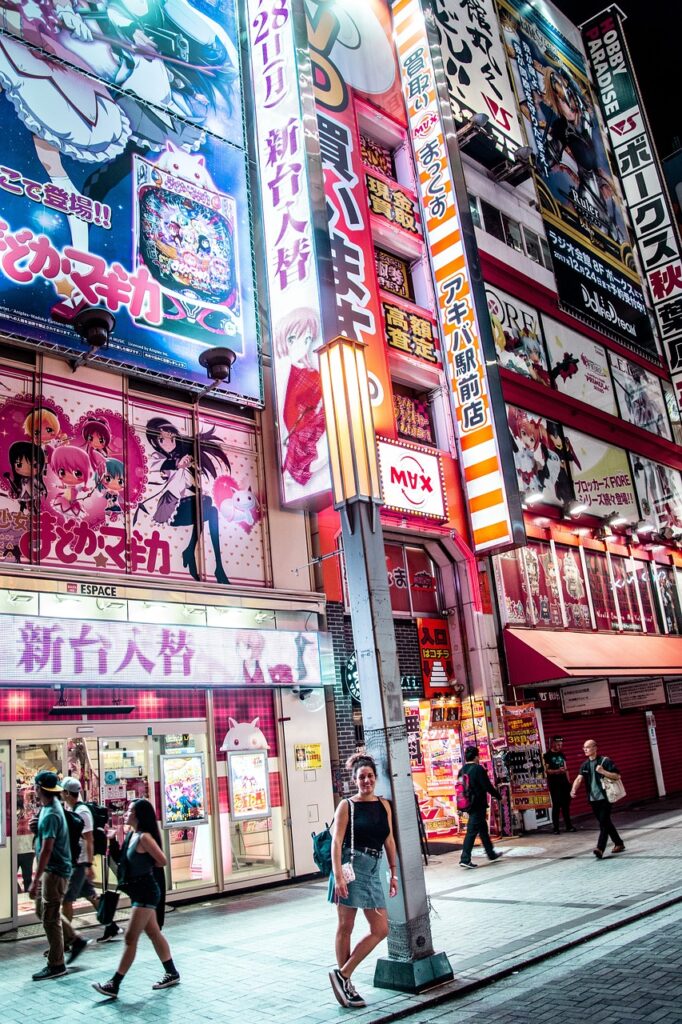  Night scene of Akihabara in Tokyo, showcasing colorful animated billboards and neon signs.