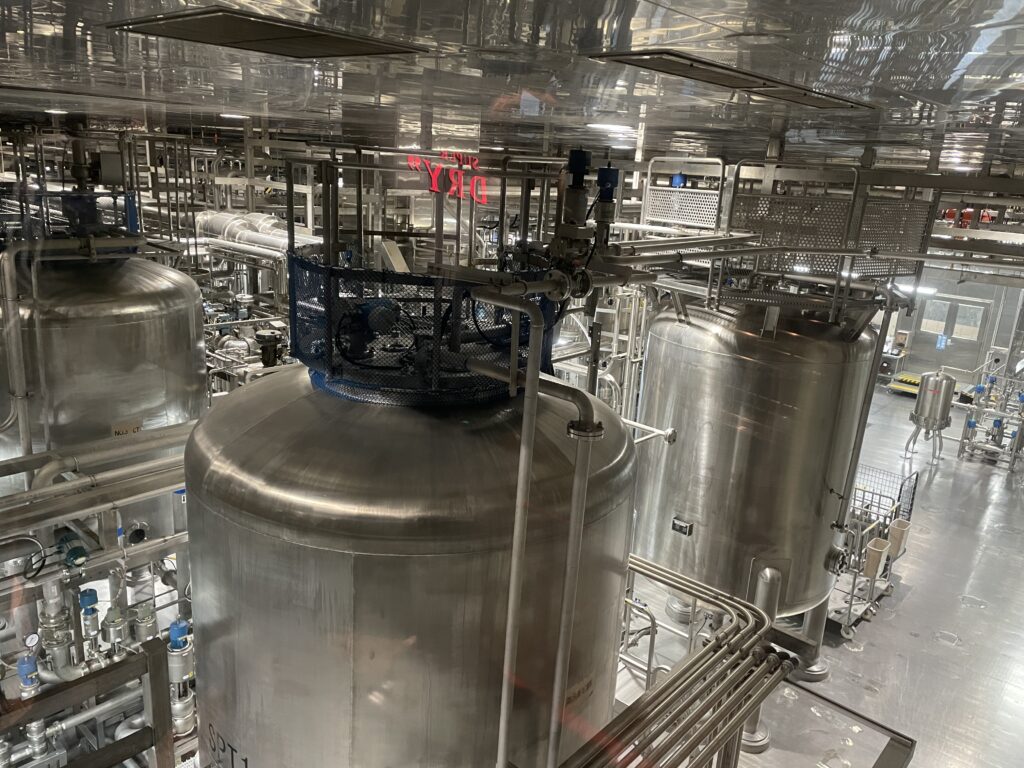 Stainless steel brewing tanks inside the Asahi Beer Museum factory tour area.