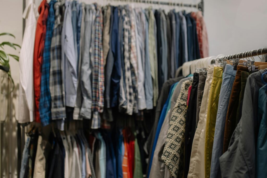 A rack of secondhand clothes in a Japanese store, offering affordable fashion options and ways to save money.