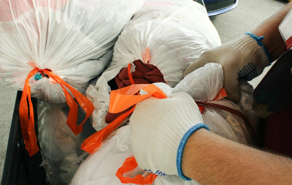 Bags of sorted trash tied with orange ribbons, prepared for collection in accordance with Japan’s strict garbage disposal rules.