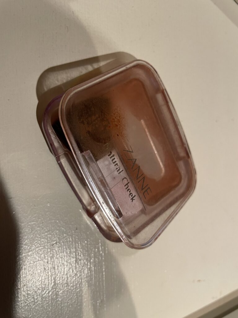  A well-used compact of Cezanne Natural Cheek blush in a translucent case, showing its popularity among users.