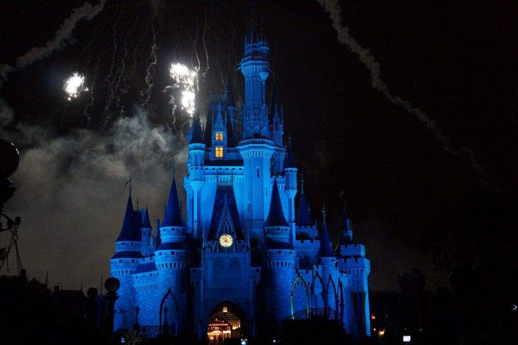  The illuminated Cinderella Castle at Tokyo Disneyland at night, with fireworks lighting up the sky.