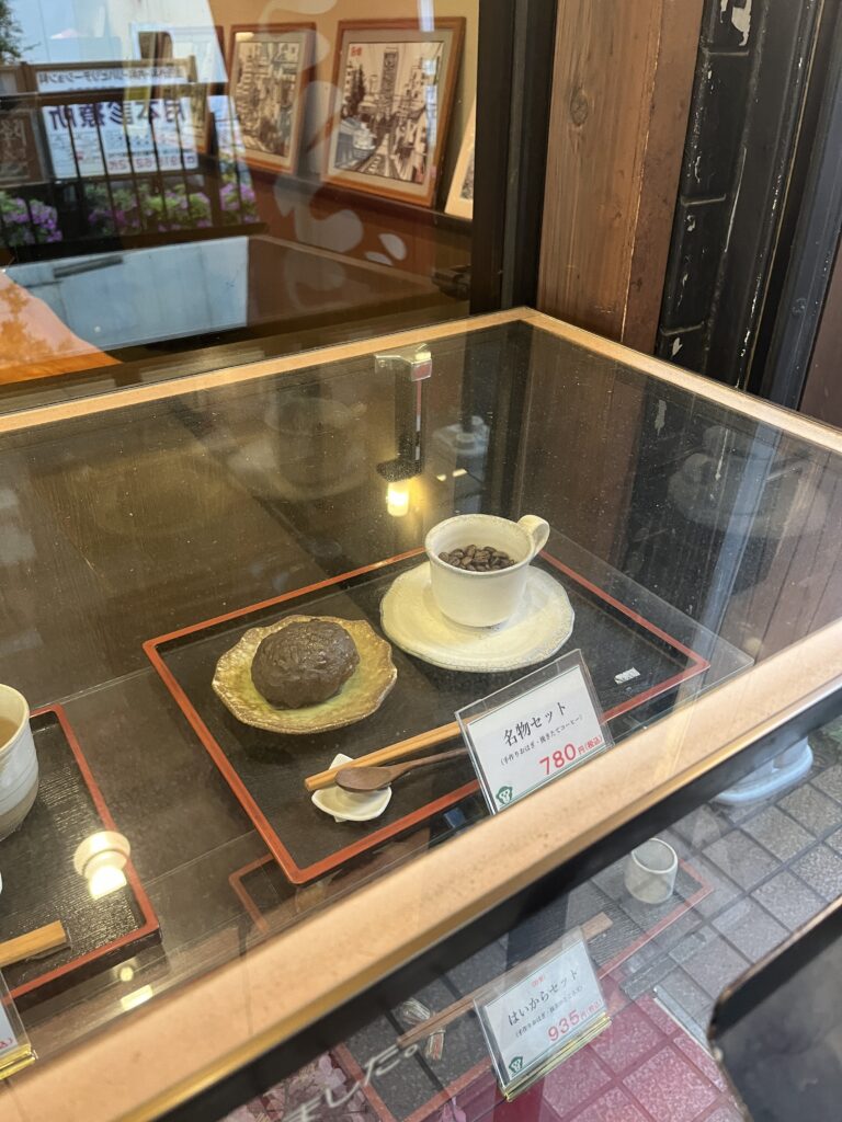  A display of sweet ohagi, glutinous rice balls coated with red bean paste, sesame, or soybean flour, priced for sale.