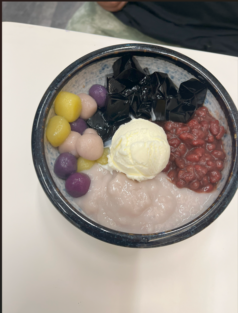 A set meal featuring a cup of sweet red bean soup and a traditional Japanese sweet, presented on a tray.