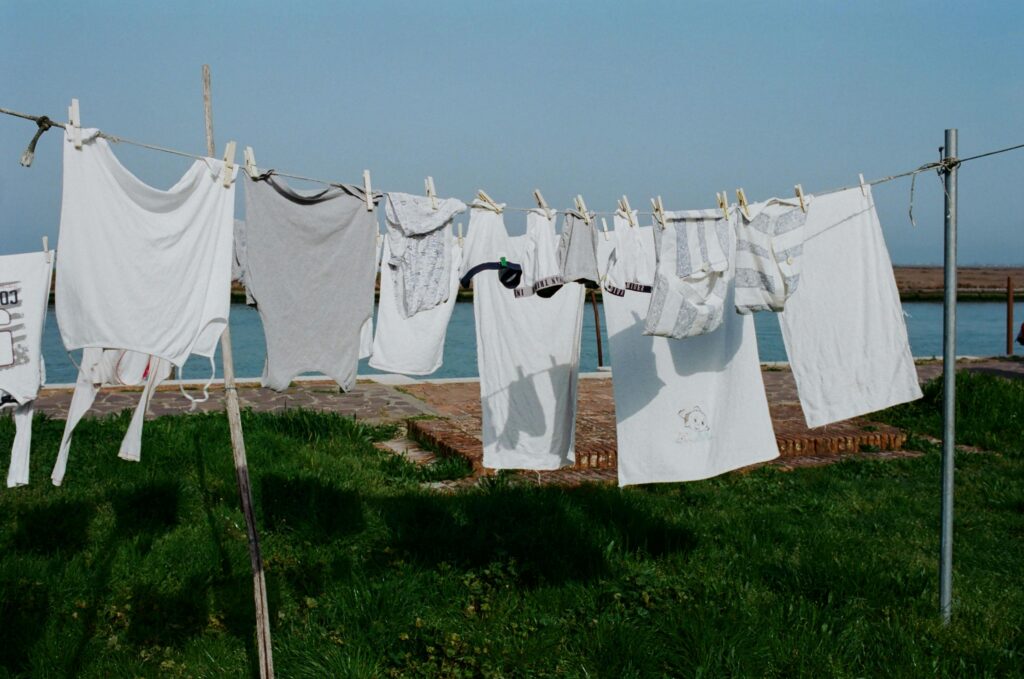 Laundry hanging on a clothesline outdoors on a sunny day.