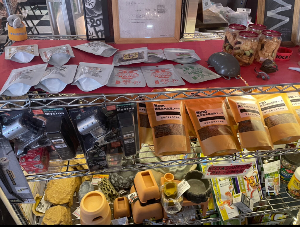  A display shelf filled with reptile supplies, snacks, and merchandise at ROCKSTAR Café.