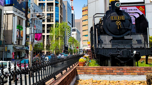 A steam locomotive on display in Shimbashi Station Square, serving as a tribute to Tokyo’s railroad history and often featured in TV interviews.