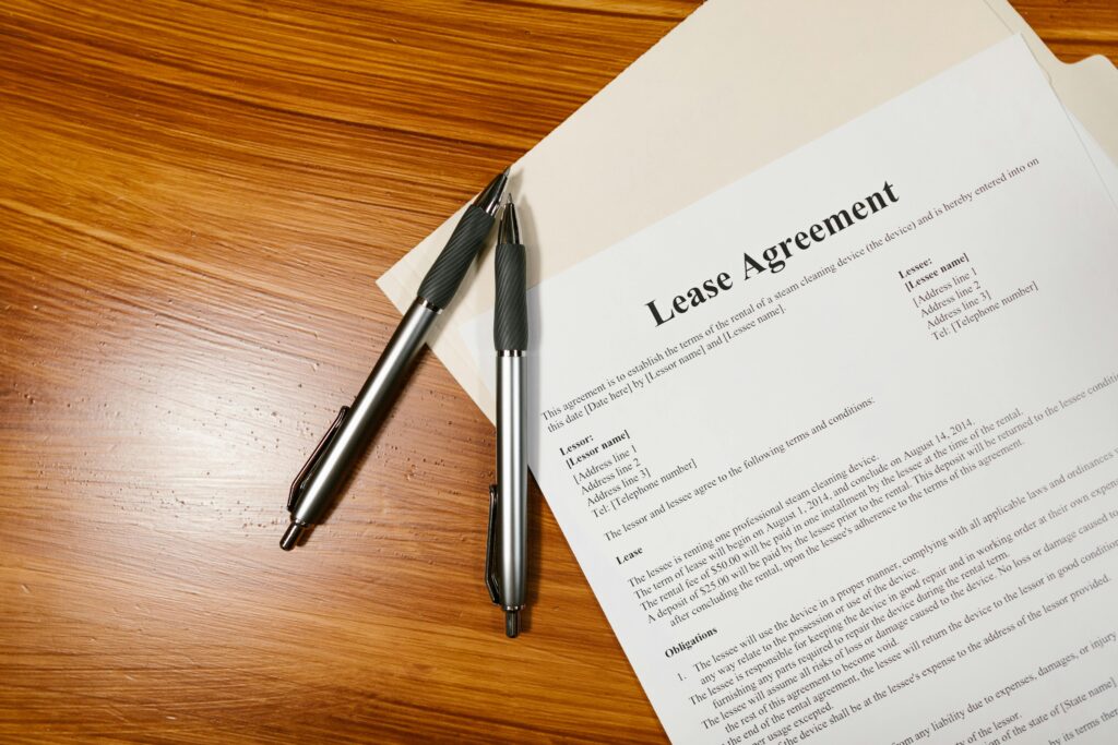 A lease agreement with two pens on a wooden desk, representing rental contracts in Tokyo.Title: Understanding Your Tokyo Lease Agreement