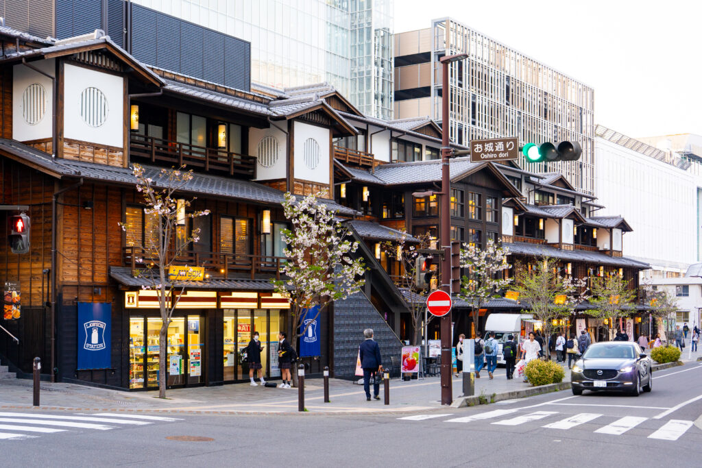 Traditional-style Minaka Odawara shopping complex along Oshiro Dori street with cherry blossoms in bloom.