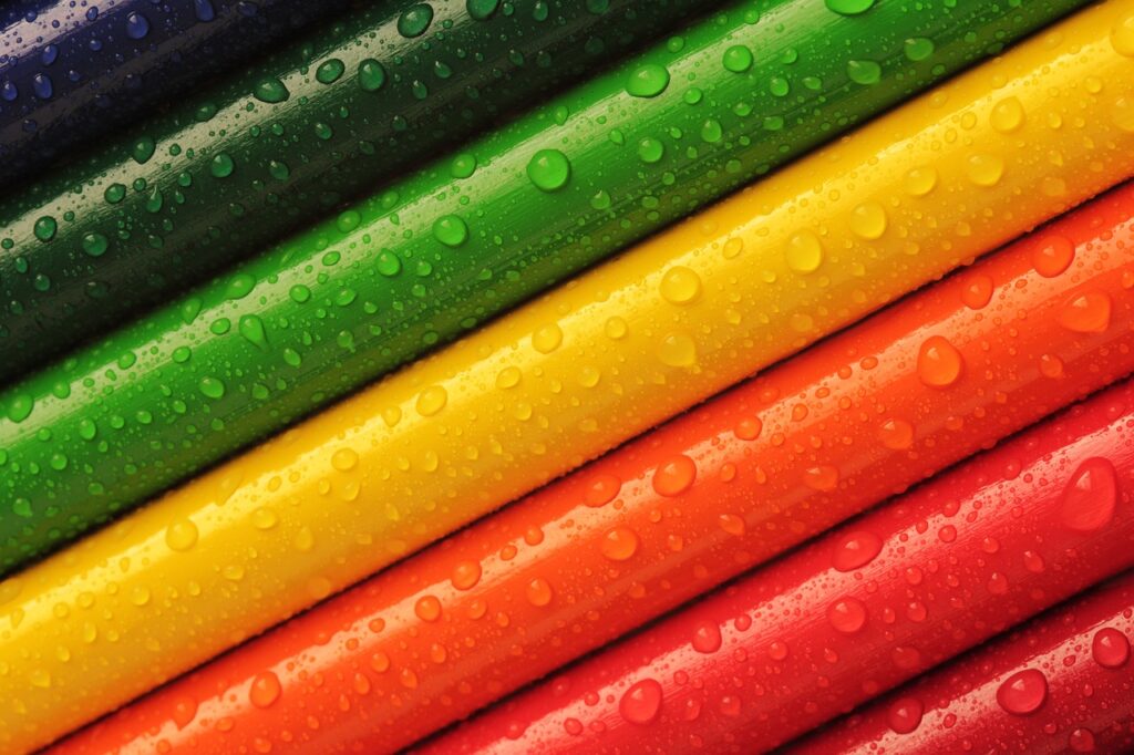 Colorful pencils with water droplets representing creative activities in Osaka