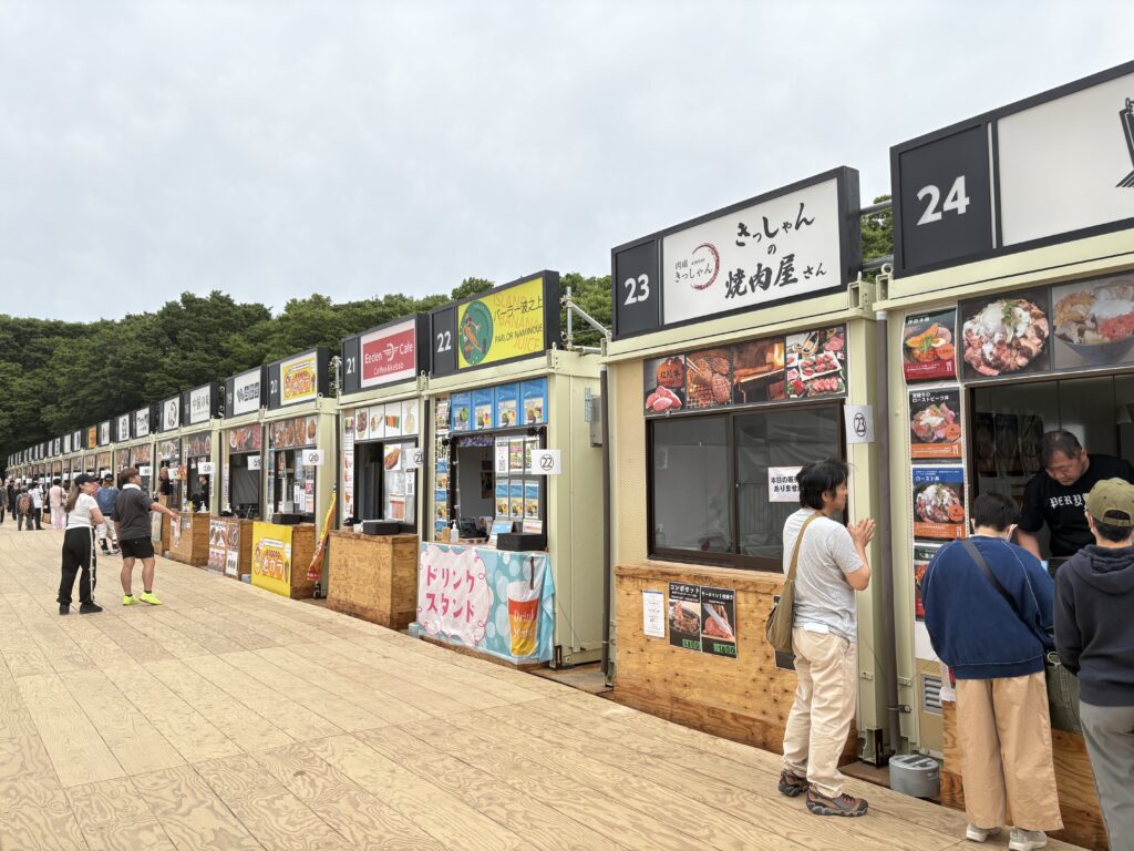 Rows of gourmet booths with various Japanese and international dishes at Osaka Castle Park.