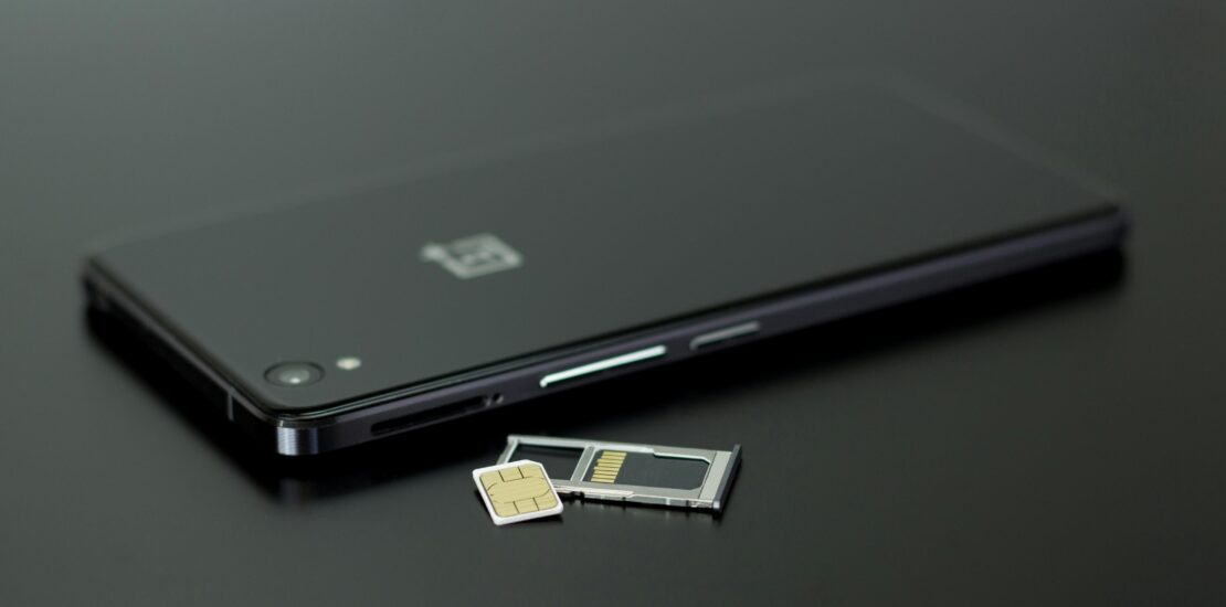 SIM card and tray next to a smartphone, ready for use in Japan