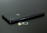 SIM card and tray next to a smartphone, ready for use in Japan