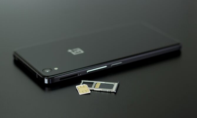 SIM card and tray next to a smartphone, ready for use in Japan