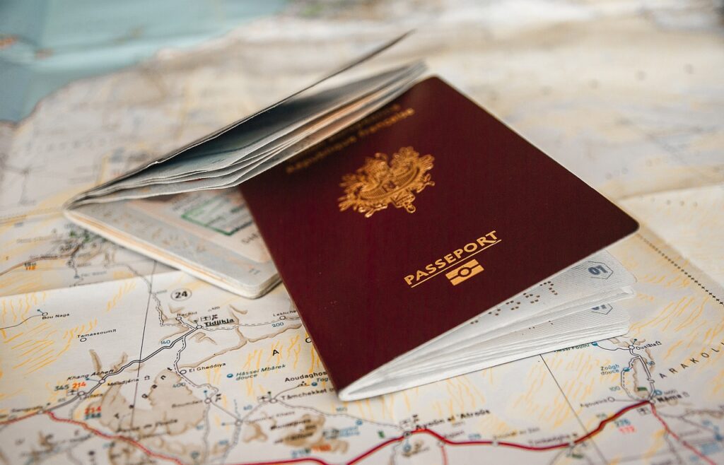 Passport placed on a map with travel documents.