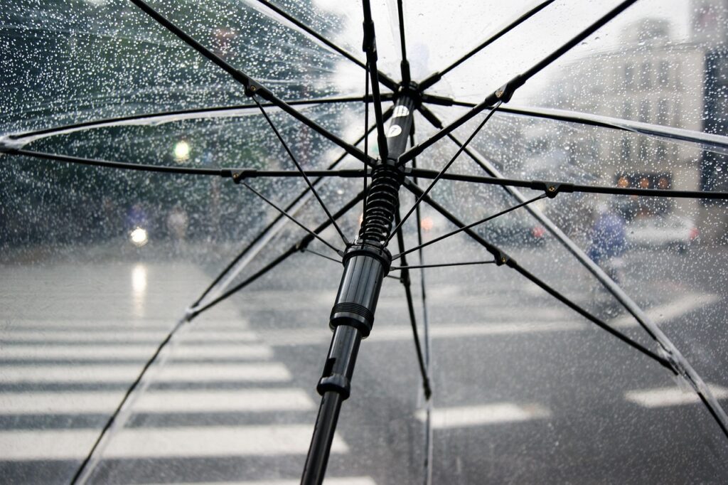  Inside view of a clear umbrella on a rainy city street in Japan