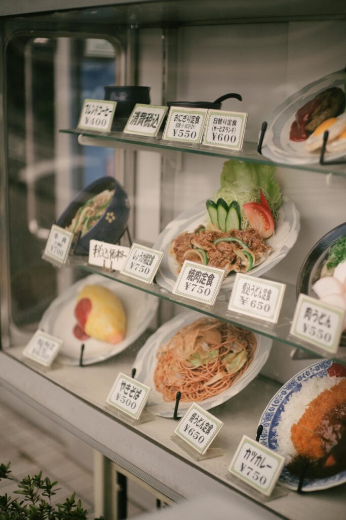 Display of plastic food models in a restaurant window.