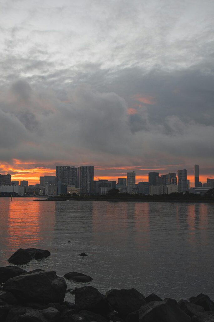 Tokyo skyline with dark storm clouds and an orange sunset.