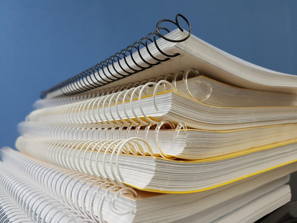 Stack of spiral-bound notebooks for language study