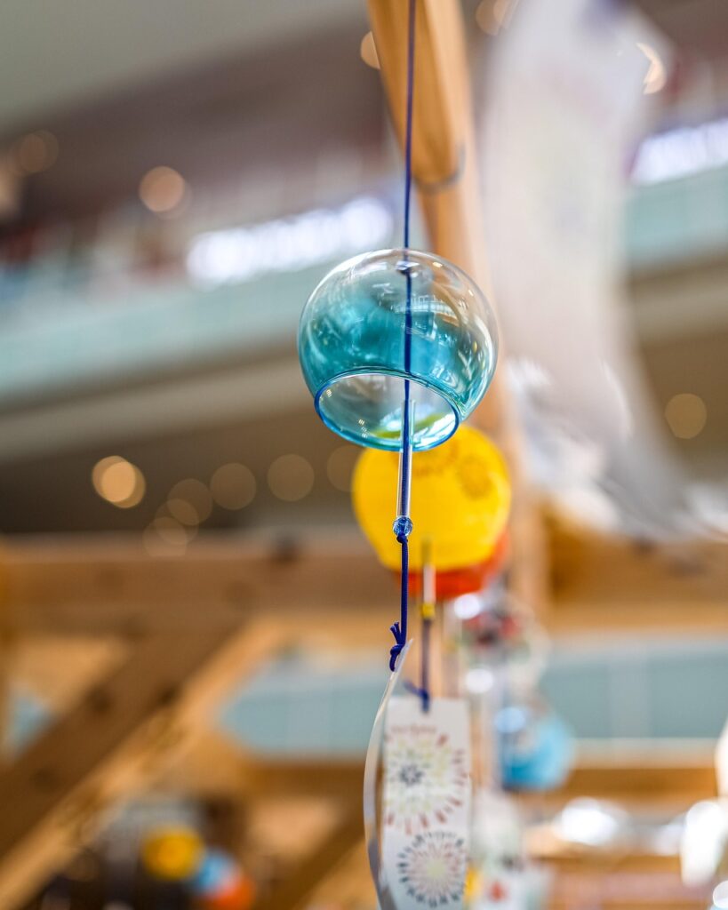 Close-up of a colorful Japanese wind chime hanging on a string.