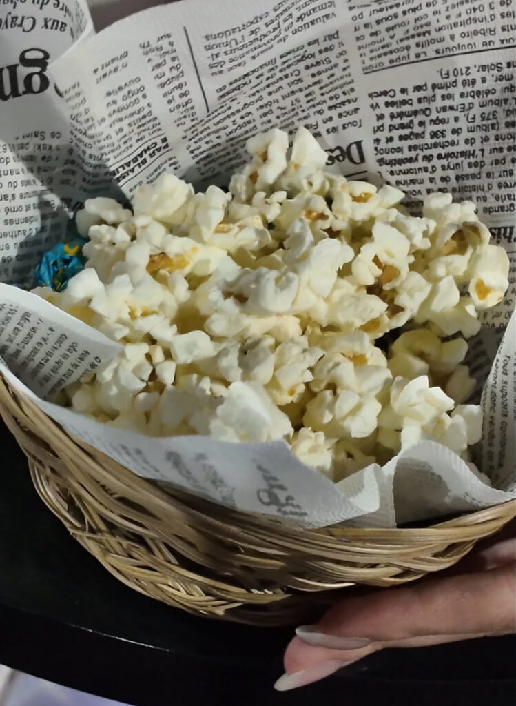 Basket of popcorn served on newspaper-style paper