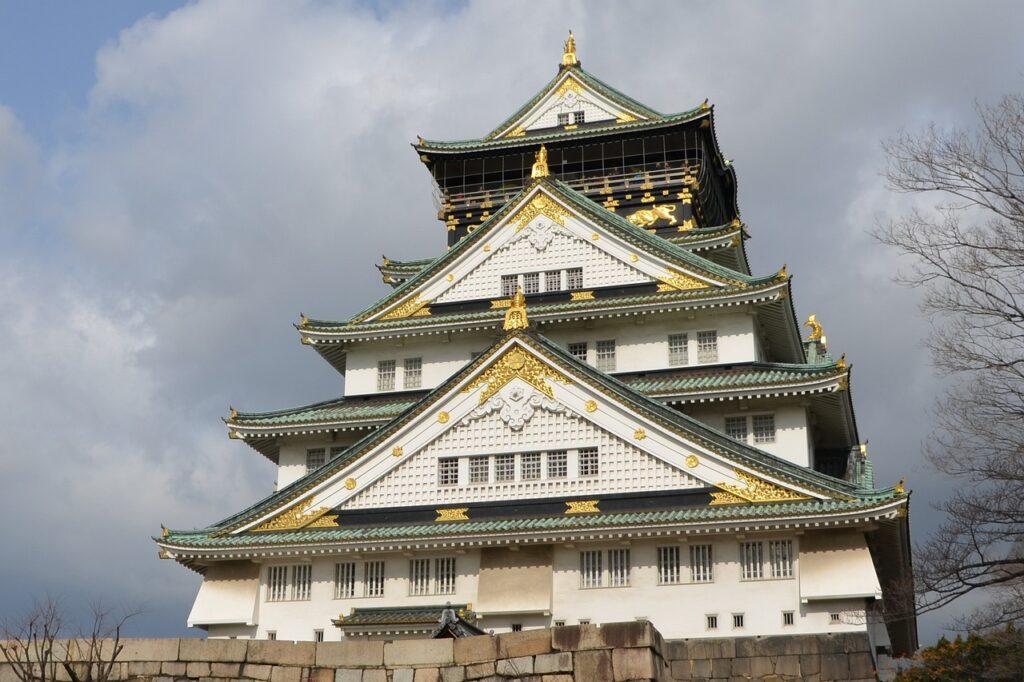 Front view of Osaka Castle with its traditional white walls and gold accents.
