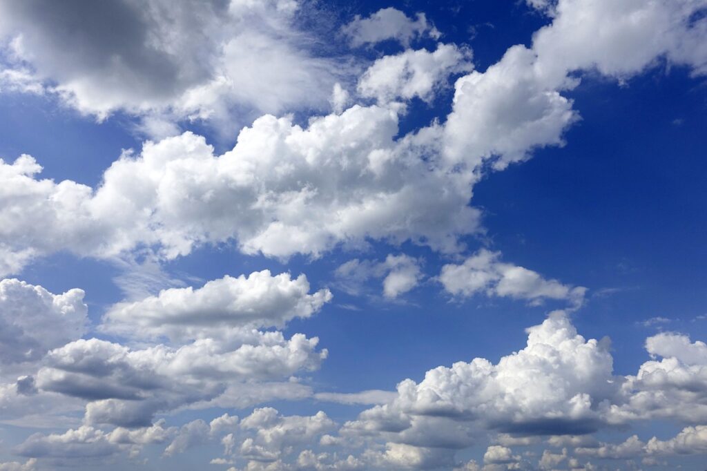 Blue sky with puffy white clouds on a sunny day.