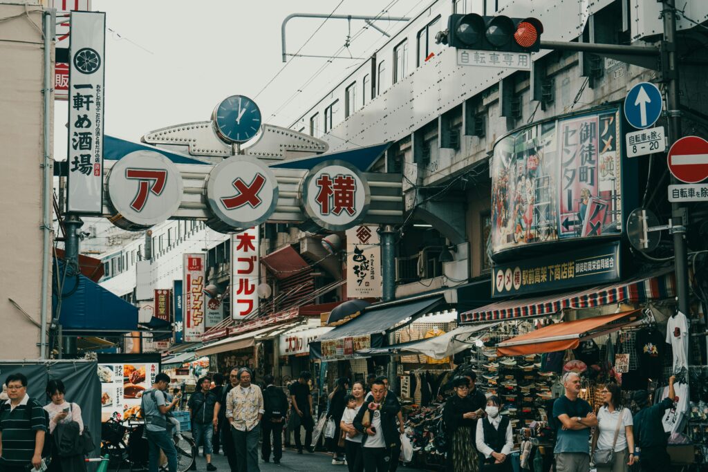 Crowds walking along Ameyokocho shopping street in the heart of the Okachimachi shopping and gold district.