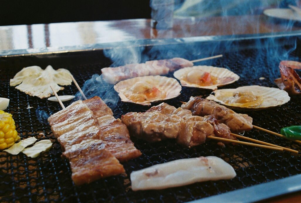 Colorful street food vendors serving finger food to visitors in Ameyokocho, Okachimachi shopping and gold district.