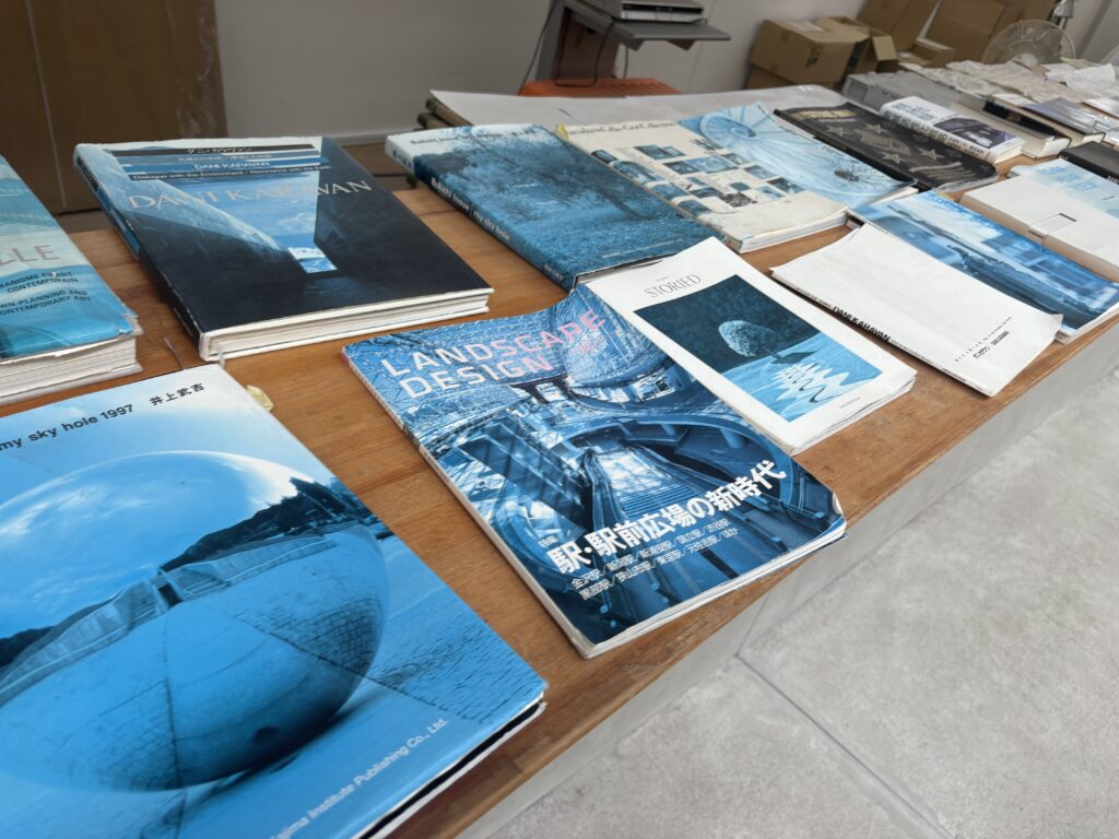 Table display of books and magazines about Dani Karavan and landscape design at Morou Art Forest.