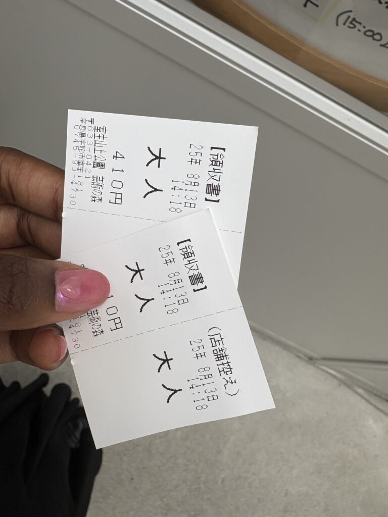 Visitor holding two admission tickets for Morou Art Forest in Nara.