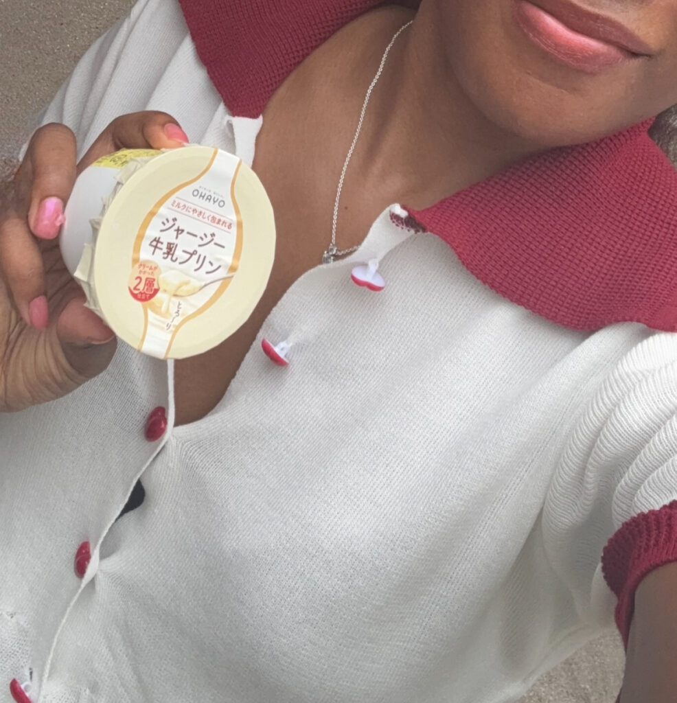 Person holding a cup of Ohayo Jersey milk pudding in Morou Art Forest.
